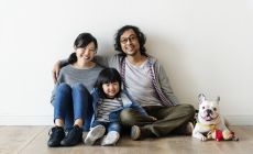 Japanese family sitting on floor with dog