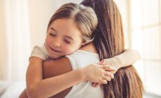 daughter hugs mother tightly